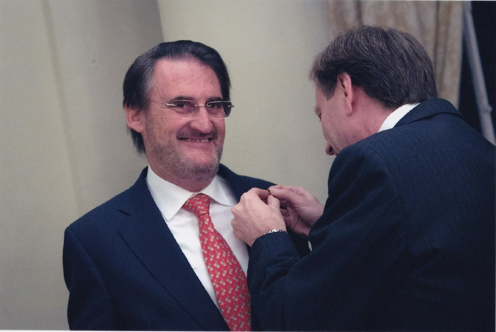 El embajador Pietro Sebastiani prende la insignia en la solapa de Jaime Revilla